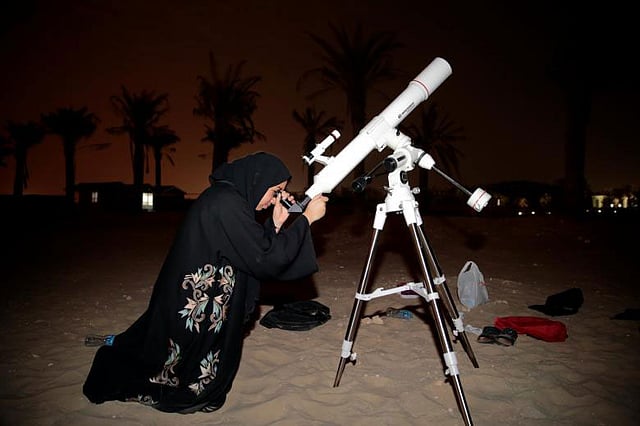 আমিরাতের জ্যোতির্বিদ সারা আল মুহহেরি টেলিস্কোপে পর্যবেক্ষণ করছেন পূর্ণগ্রাস চন্দ্রগ্রহণ। আবুধাবি, সংযুক্ত আরব আমিরাত। ছবি: রয়টার্স