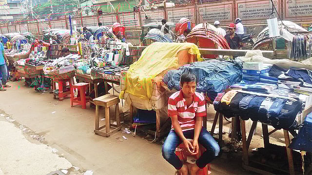 গোলচত্বর ঘিরে ফুটপাতে প্রতিদিন দুই হাজার হকার বসেন। এতে পথচারীদের চলাচলে ভোগান্তি পোহাতে হয়। ছবিটি গত রোববার তোলা। প্রথম আলো
