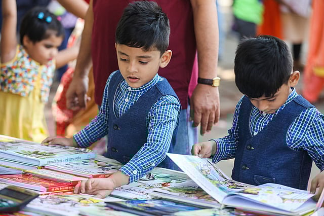 বই দেখছে দুই ভাই।