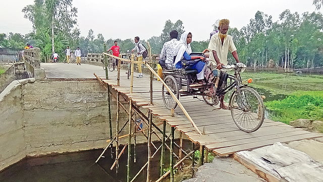 একটু অসতর্ক হলেই পড়বে খাদে। সাঘাটা-গোবিন্দগঞ্জ সড়কের মধ্য বাটি গ্রামে। ছবি: প্রথম আলো