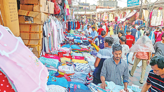 দোকানের সামনে পণ্যের পসরা সাজিয়ে বসেছেন হকাররা। গত শনিবার নিউমার্কেটের ভেতরে। ছবি: প্রথম আলো