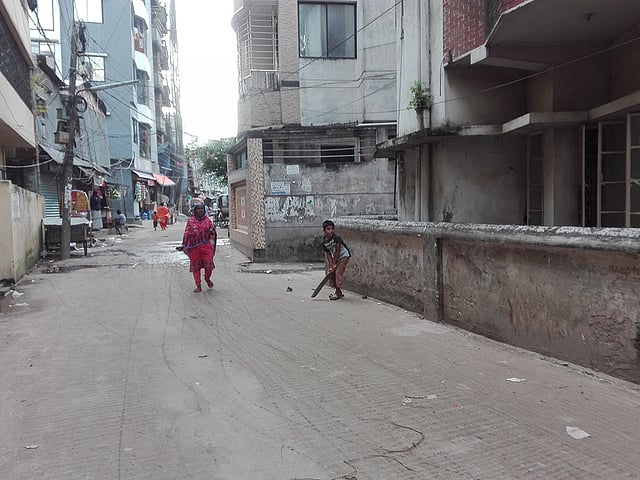 বাসার পাশের সড়কে শিশুর ক্রিকেট অনুশীলন। মধুবাগ, মগবাজার, ঢাকা। ছবি: প্রথম আলো