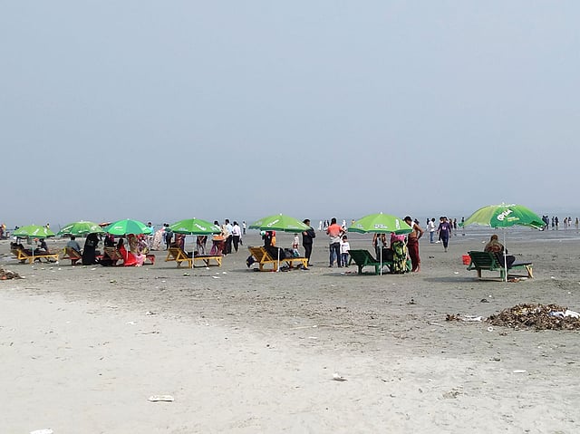 মিনি কক্সবাজারের বিচের চেয়ারে শুয়ে আছেন পর্যটকেরা। ছবি: লেখক