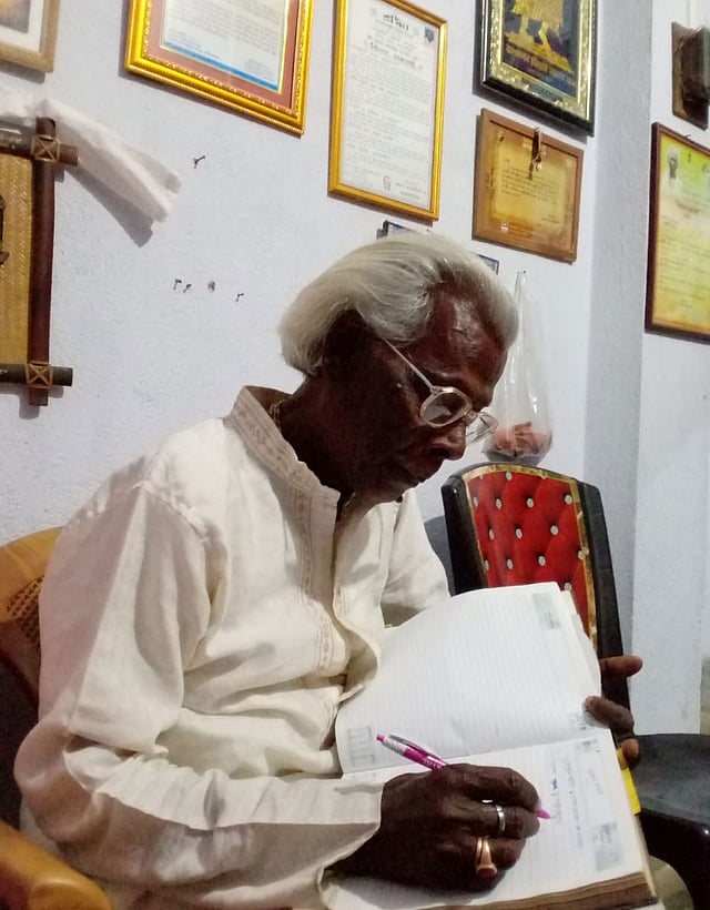 নিজের ঘরে বসে লিখছেন গীতিকবি রতন কাহার। ছবি: সংগৃহীত