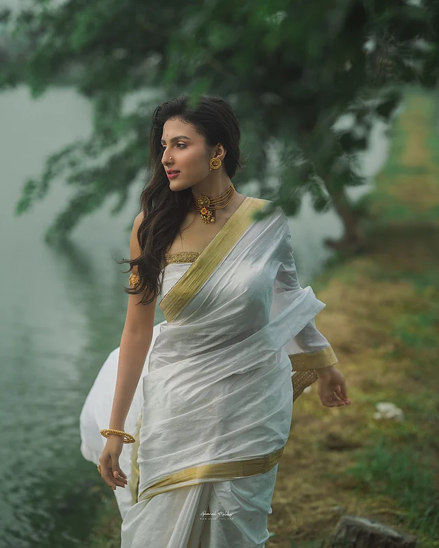 সাদা জমিন, সোনালি পাড়ের কেরালা কটন শাড়িতে যেন অপ্সরীর মতোই লাগছেন তিনি। সঙ্গে সোনায় গয়নায় সেজেছেন তিনি
