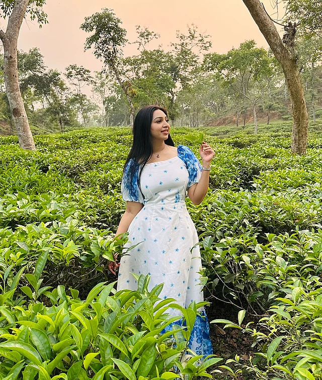 চা বাগানের মাঝে সাদা-নীল ড্রেসে দেখা দিয়েছেন তিনি