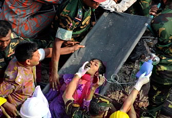 Bangladeshi rescuers retrieve garment worker Reshma from the collapsed Rana Plaza building in Savar on the outskirts Dhaka on 10 May 2013. Photo: AFP