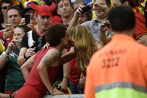Belgium's midfielder Axel Witsel kisses his girlfriend after the Group H football match between Belgium and Russia at the Maracana Stadium in Rio de Janeiro during the 2014 FIFA World Cup on June 22, 2014. AFP