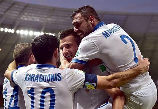Greece's midfielder Andreas Samaris (C) celebrates with teammates after scoring a goal during the Group C football match between Greece and Ivory Coast at the Castelao Stadium in Fortaleza during the 2014 FIFA World Cup on June 24, 2014. AFP