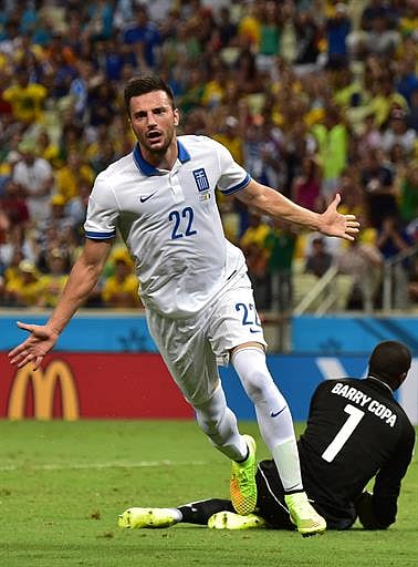 Greece's midfielder Andreas Samaris celebrates after scoring a goal during the Group C football match between Greece and Ivory Coast at the Castelao Stadium in Fortaleza during the 2014 FIFA World Cup on June 24, 2014. AFP