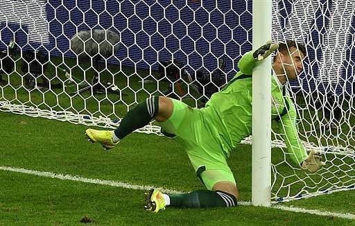 Russia's goalkeeper Igor Akinfeev collides with the post after making a save during the Group H football match between Algeria and Russia at The Baixada Arena in Curitiba on June 26, 2014, during the 2014 FIFA World Cup. AFP
