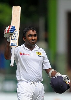 In this file photograph taken on July 24, 2014, Sri Lankan batsman Mahela Jayawardene raises his bat and helmet in celebration after scoring a century (100 runs) during the opening day of the second Test match between Sri Lanka and South Africa at the Sinhalese Sports Club (SSC) Ground in Colombo. AFP