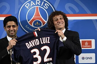 PSG newly recruited Brazilian defender David Luiz (R) holds his new jersey with PSG chairman Nasser Al-Khelaifi during his official presentation, on August 7, 2014 in Paris. AFP