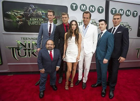 Cast members (from L-R) Danny Woodburn, Jeremy Howard, Alan Ritchson, Megan Fox, Will Arnett, Noel Fisher and Pete Ploszek pose at the premiere of ''Teenage Mutant Ninja Turtles'' in Los Angeles, California on August 3, 2014. Reuters