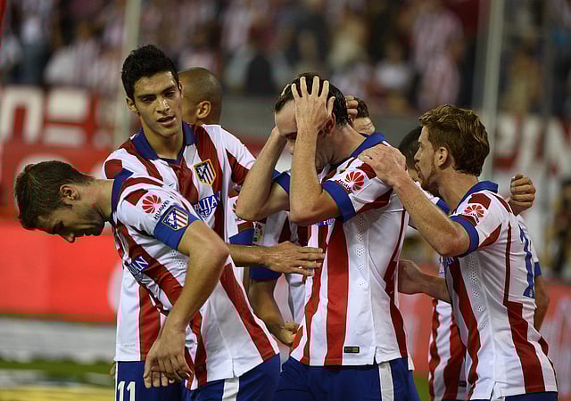 Atletico Madrid's Uruguayan defender Diego Godin is congratulated by his teammates after scoring their second goal during the Spanish league football match Club Atletico de Madrid vs Celta de Vigo. Photo: AFP