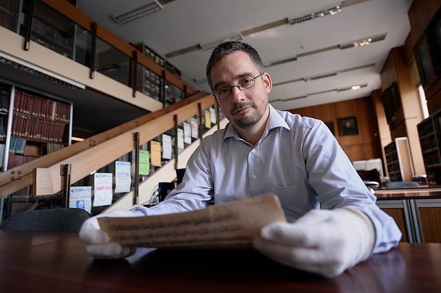 This photo taken on September 17, 2014 shows head of the music collection Balazs Mikusi of the National Szechenyi Library presenting a never before known manuscript of one of the most recognised tunes of Wolfgang Amadeus Mozart, the A major sonata in Budapest. Photo: AFP