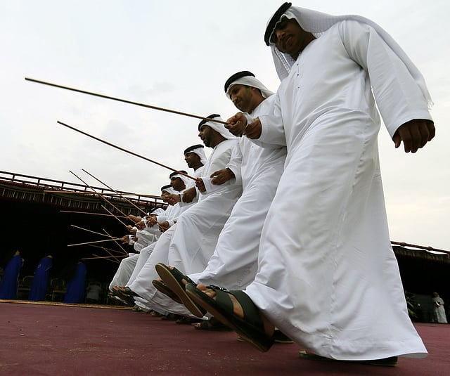 Emirati men holding canes as they perform a local traditional Bedouin folklore dance during the Sheikh Sultan Bin Zayed al-Nahyan camel festival, at the Shweihan racecourse, in Al-Ain in the outskirts of Abu Dhabi. Photo: AFP