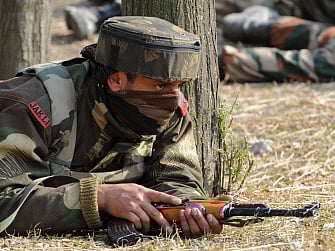An Indian soldier takes position by a road overlooking army barracks following an attack by militants on the camp in Gingal Uri, some 90 kms north of Srinagar near the Line of Control (LoC), on December 5, 2014. AFP