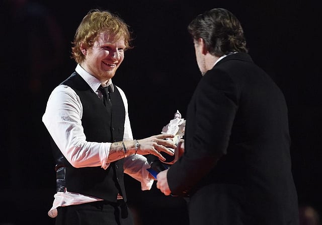 Ed Sheeran celebrates with Russell Crowe after receiving the British Album of the Year award at the BRIT music awards. Photo: Reuters