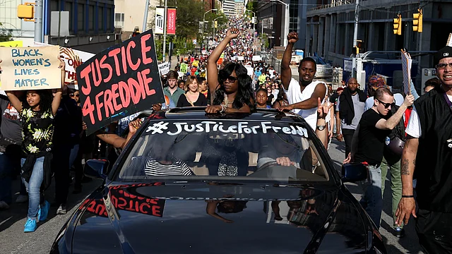 Protesters march on the street from City Hall a day after Baltimore authorities released a report on the death of Freddie Gray, May 2, 2015 in Baltimore, Maryland. AFP