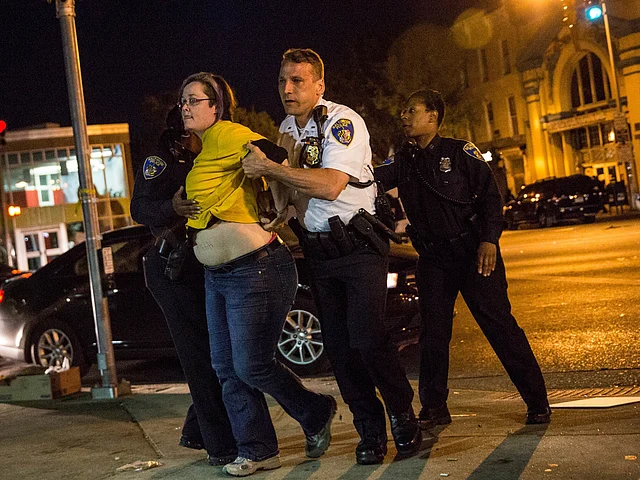 A woman is arrested by police at the end of a day of protests in the Sandtown neighborhood where Freddie Gray was arrested on May 2, 2015 in Baltimore, Maryland. Gray later died in custody. AFP