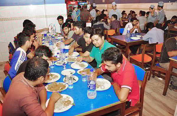 A group of 13 friends are having sehri at Dhaka's Hotel Al-Razzak on early Wednesday. Photo: Abdus Salam
