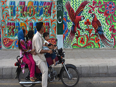 A Pakistani family looks at art work on a wall on a commercial street in the southern port city of Karachi. Photo: AFP