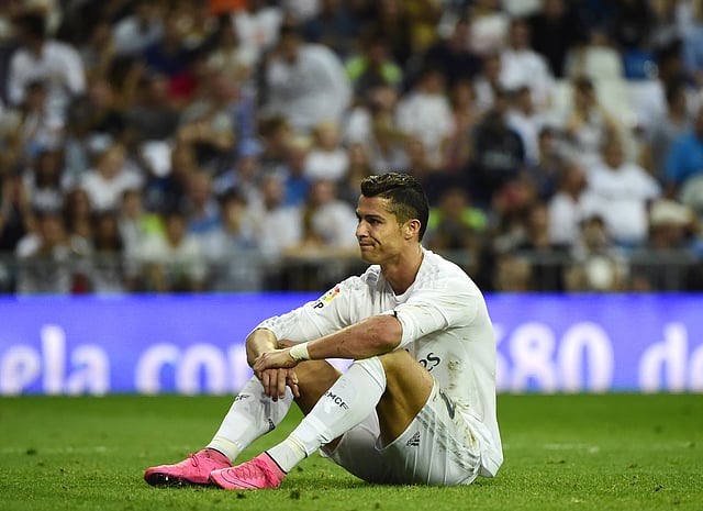 Real Madrid's Portuguese forward Cristiano Ronaldo sits on the ground during the Spanish league football match Real Madrid CF vs Malaga CF at the Santiago Bernabeu stadium in Madrid on September 26, 2015. AFP