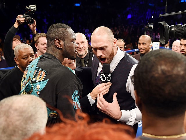 Tyson Fury of Britain (R) challeges Deontay Wilder of the US (L) after Wilder defeated Artur Szpilka of Poland in their WBC Heavyweight Championship bout at Barclay`s Center in Brooklyn. Photo: AFP