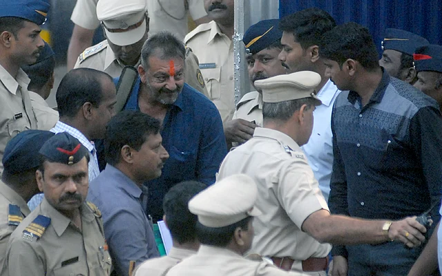 Indian Bollywood actor Sanjay Dutt (C) is escorted by officials from Yerwada Jail in Pune. Photo: AFP