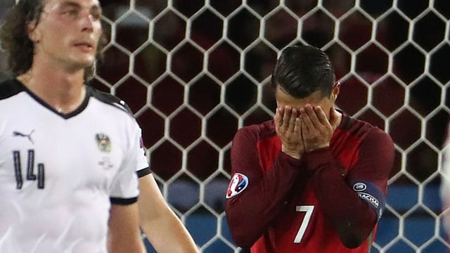 Portugal’s forward Cristiano Ronaldo ® reacts after missing a penalty kick beside Austria’s midfielder Julian Baumgartlinger during the Euro 2016 group F football match at the Parc des Princes in Paris. Photo: AFP