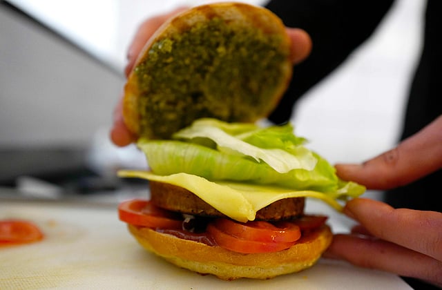 This file photo taken on April 29, 2016 shows Chef Johannes Thenerl preparing a vegan `burger` using a patty made of wild garlic (Baerlauch) at the vegan restaurant `L`Herbivore` in Berlin. Photo: AFP