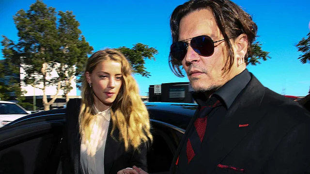 US actor Johnny Depp ® and his wife Amber Heard arriving at a court in the Gold Coast in Australia. Photo: AFP
