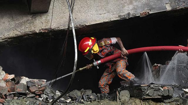 A Bangladeshi firefighter works to put out a fire at the site of an explosion in a factory in the key Bangladeshi garment manufacturing town of Tongi, just north of the capital Dhaka, on September 10, 2016. Photo: AFP