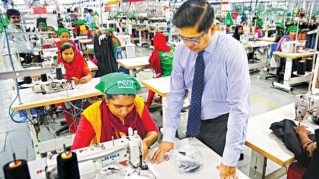 Managing director Miran Ali of Remi Holdings, one of the top three environment-friendly garment and textile factories, seen instructing an employee. Photo: Hassan Reza