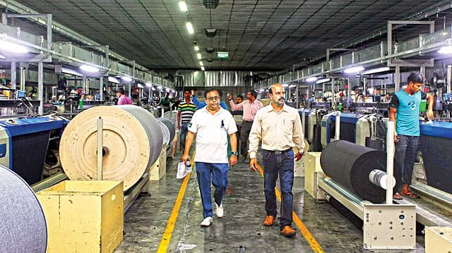 Chairman and founder of Envoy Group Kutubuddin Ahmed (L) framed in Envoy Textiles factory in Mymensingh that topped as an environment friendly factory for Denim production. Photo: Shahadat Parvez