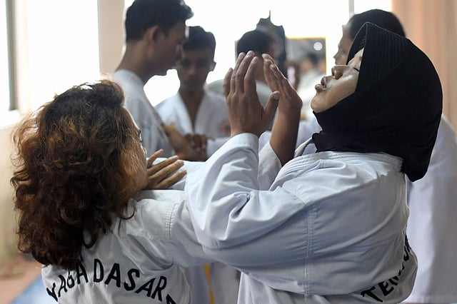 This picture taken on 2 October, 2016 shows students during a training session in the ancient Indonesian martial art of `pencak silat` in Jakarta. Photo: AFP
