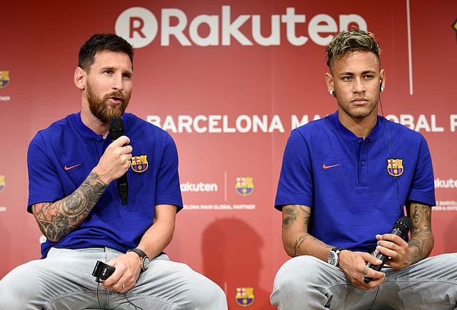 FC Barcelona football star Lionel Messi (L) answers questions beside teammate Neymar (R) during a press conference to announce new sponsorship with Japanese internet retailer Rakuten in Tokyo on 13 July, 2017. Photo: AFP