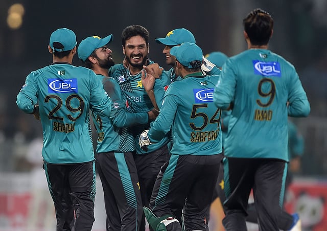 Pakistani bowler Rumman Raees (C) celebrates with teammate Ahmed Shahzad after taking the wicket of World XI batsman Tamim Iqbal during the first Twenty20 international cricket match between the World XI and Pakistan at The Gaddafi Cricket Stadium in Lahore on 12 September. Photo: AFP