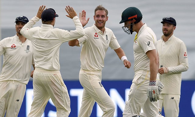 England`s bowler Stuart Broad (C) celebrates with teammates after dismissing Australia`s Shaun Marsh (2nd R) on the final day of the fourth Ashes cricket Test match at the MCG in Melbourne on 30 December 2017. AFP