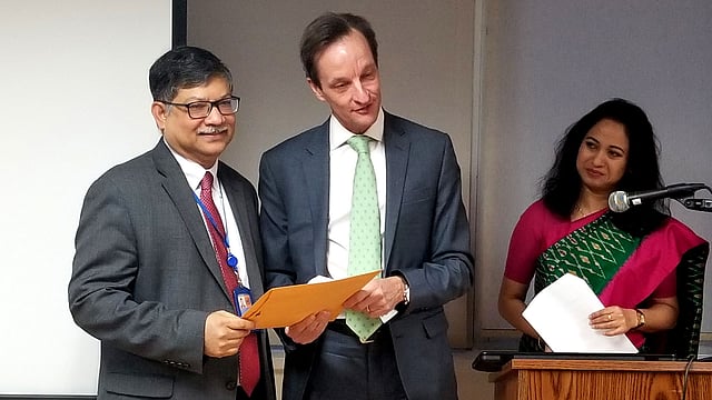 Roland Mollerus (M), chief of the CDP secretariat, hands over to permanent representative of Bangladesh, ambassador Masud Bin Momen an official letter at an event organised at the Bangabandhu auditorium of Bangladesh mission in New York on Friday. Photo: Bangladesh Mission in NY