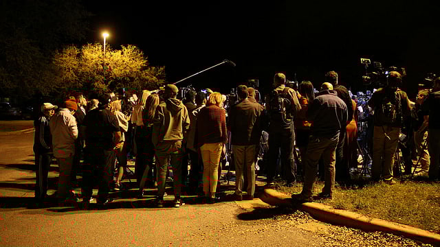 Members of the media and onlookers surround Austin assistant police chief Ely Reyes as he addresses the media regarding an incident that law enforcement personnel said involved an incendiary device in the 9800 block of Brodie Lane in Austin, Texas, US on 20 March 2018. Photo: Reuters