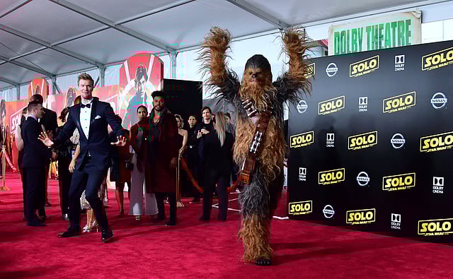Actor Joonas Suotamo (L), who plays Chewbacca, reacts as a person in a Chewbacca suit gestures on the red carpet at the premiere of the film `Solo: A Star Wars Story` in Hollywood, California on 10 May, 2018. Photo: AFP