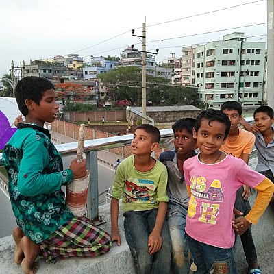 Rashed and his kite flier friends pose for a picture. A recently taken photo from Hatirjheel, Dhaka by Nusrat Nowrin