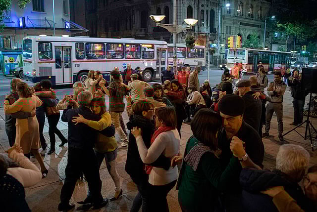 People dance tango at Entrevero square on Montevideo`s main avenue on 25 May 2018. The Montevideo city government is getting ready to launch a strategic plan, based on an assessment of the state of tango in Uruguay, to strengthen and revive this art form that emerged simultaneously in Buenos Aires and Montevideo in the late 19th century. Photo: AFP