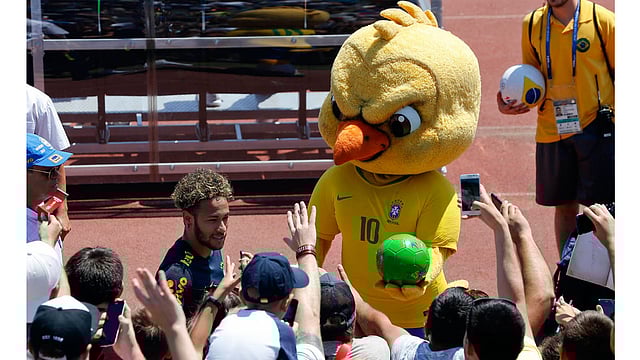 In this Tuesday, 12 June 2018 file photo Brazil`s mascot holds a soccer ball as fans cheer Brazil`s Neymar as he leaves a training session in Sochi, Russia. It took an angry-looking bird to get Brazilians hooked on their World Cup mascot. Brazil historically never fully embraced the tradition of mascots in sports, but things changed when the soccer federation _ inspired in part by Chicago Bull`s `Benny the Bull` _ turned its cute-looking `Canary` into a mean figure that represents the fans` anger following the humiliating home loss at the World Cup four years ago. Photo : AP