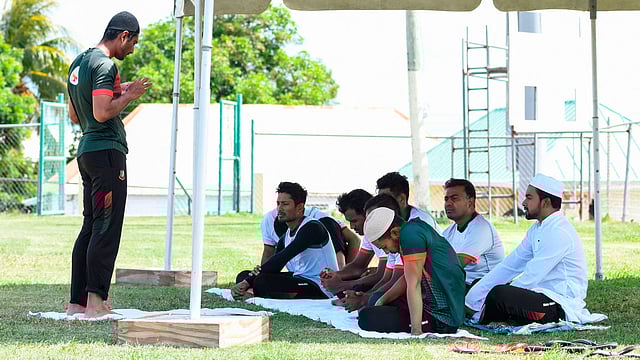 Mahmudullah (L) of Bangladesh leads the team in prayers take part in a training session one day ahead of the 3rd and final ODI match between West Indies and Bangladesh at Warner Park, Basseterre, St. Kitts, on 27 July 2018. Photo: AFP
