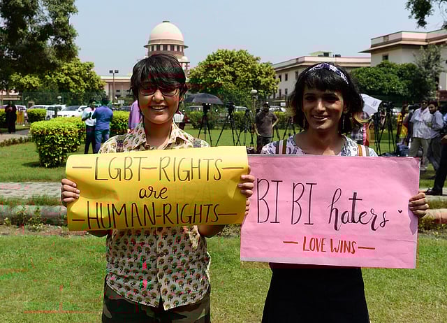 Indian members of the lesbian, gay, bisexual, transgender (LGBT) community hold placards outside the Supreme Court building as crowds gathered to celebrate the decision to strike down the colonial-era ban on gay sex in New Delhi on 6 September 2018. Photo: AFP