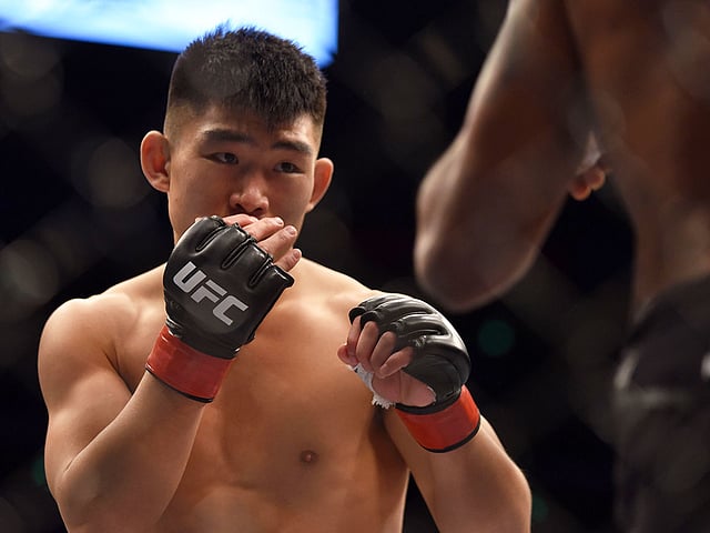 In this file photo taken on 25 November 2017 Song Yadong (L) of China competes against Bharat Kandare of India during their UFC men`s featherweight event at the UFC Fight Night in Shanghai. Song Yadong was so obsessed with Chinese martial arts that he convinced him mother to pack him up and send him off to learn at the feet of the famous kung fu masters of Shaolin. Photo: AFP