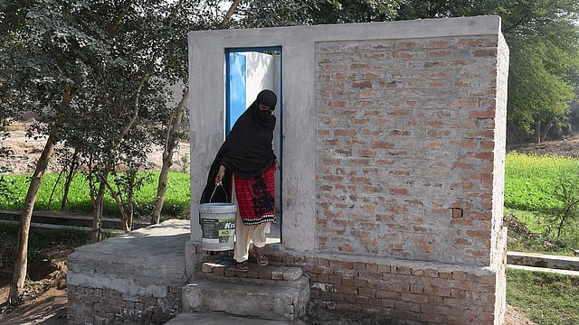In this picture taken on 15 November 2018, a Pakistani woman comes out from a toilet in Basti Ameerwala village in central Punjab province. Photo: AFP 2. In this picture taken on 15 November 2018, a Pakistani woman pumps water from a hand pump next to a toilet in Basti Ameerwala village in central Punjab province. Photo: AFP